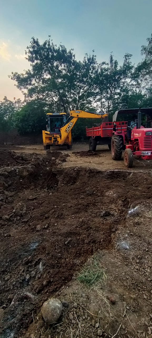 JCB loading excavated earth during site excavation