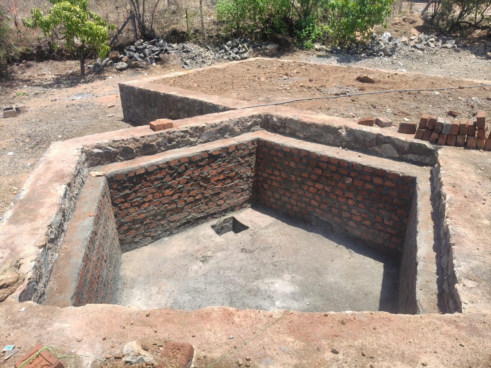 Brick-lined water storage tank built under the courtyard, within the plinth structure